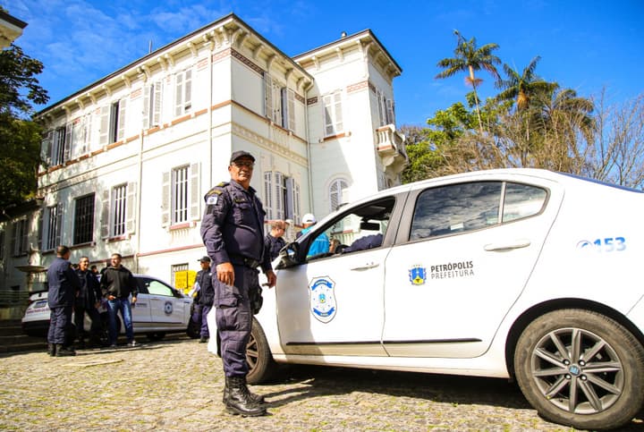 Guarda civil municipal de Petrópolis ao lado de viatura da corporação