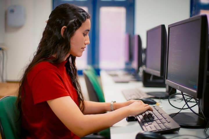 Mulher mexendo em um computador para fazer prova online