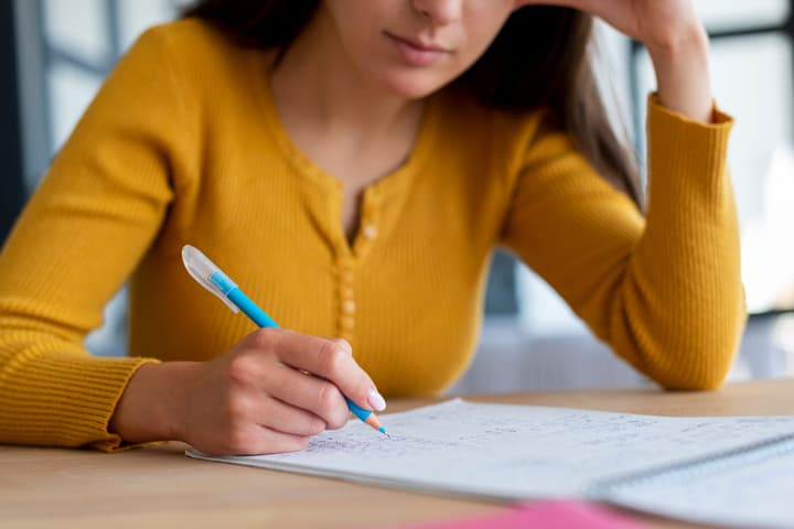 menina estuda para concurso em caderno